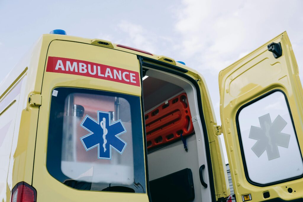 pexels-photo-8943252-8943252 Yellow ambulance with open doors displaying medical interior equipment, emphasizing emergency response.